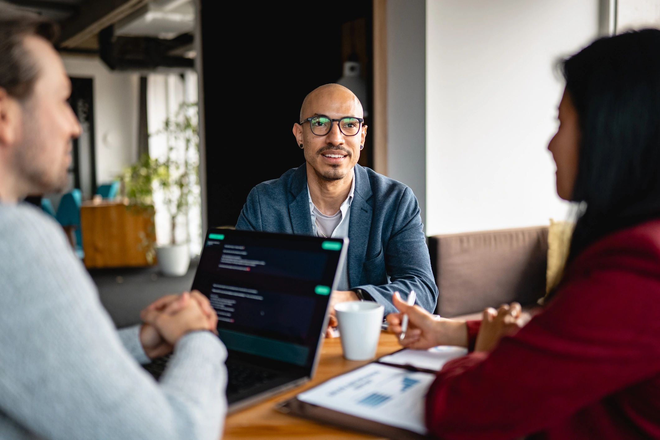 Attorneys meeting with a client in a professional office