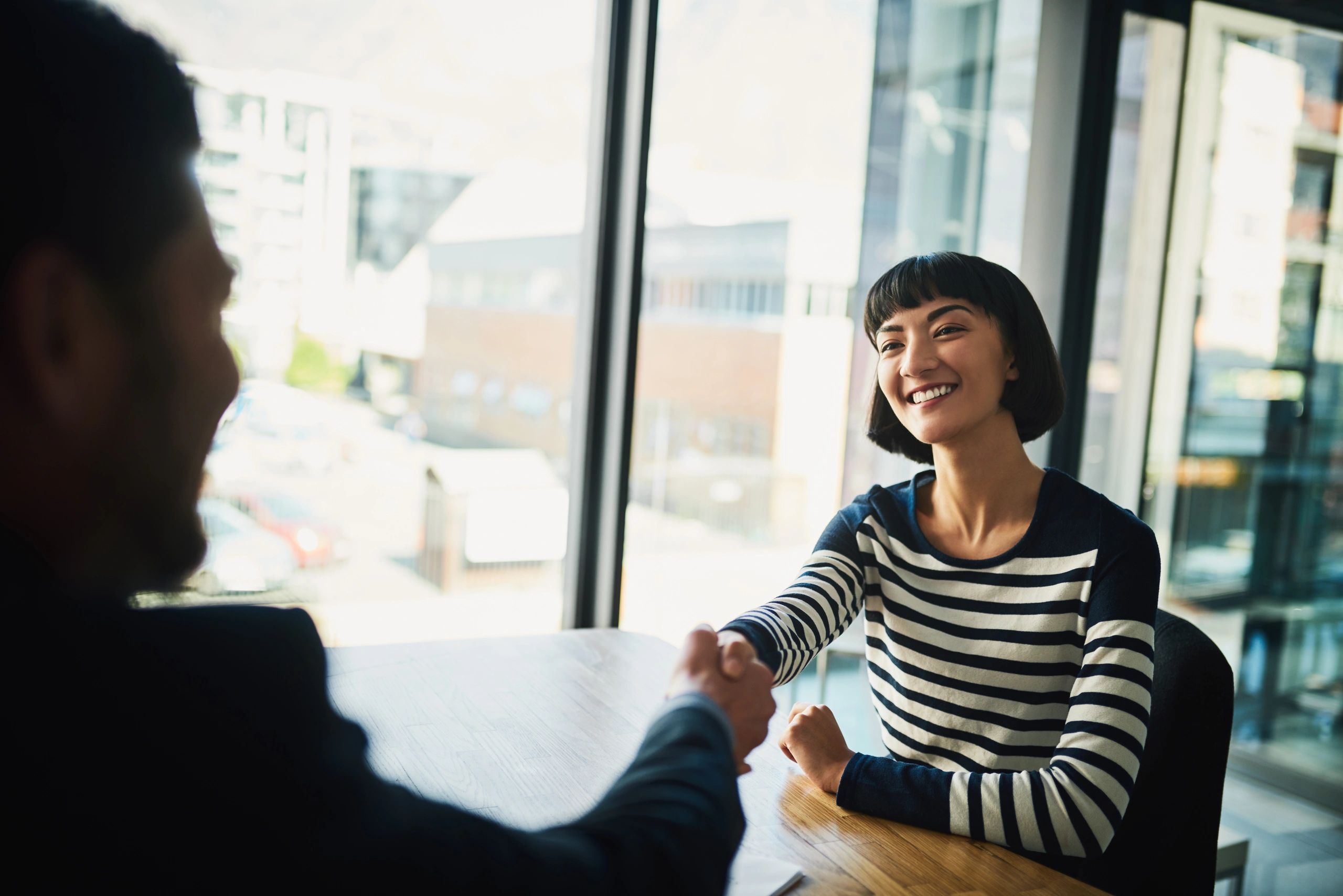 Attorney and client shaking hands after a successful meeting